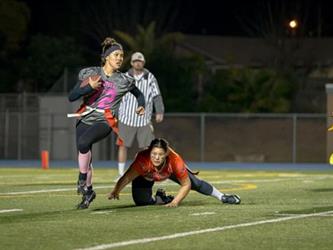 Powder Puff players playing a game at night