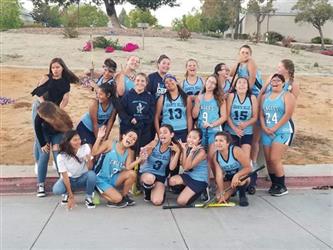 Field hockey players posing outside